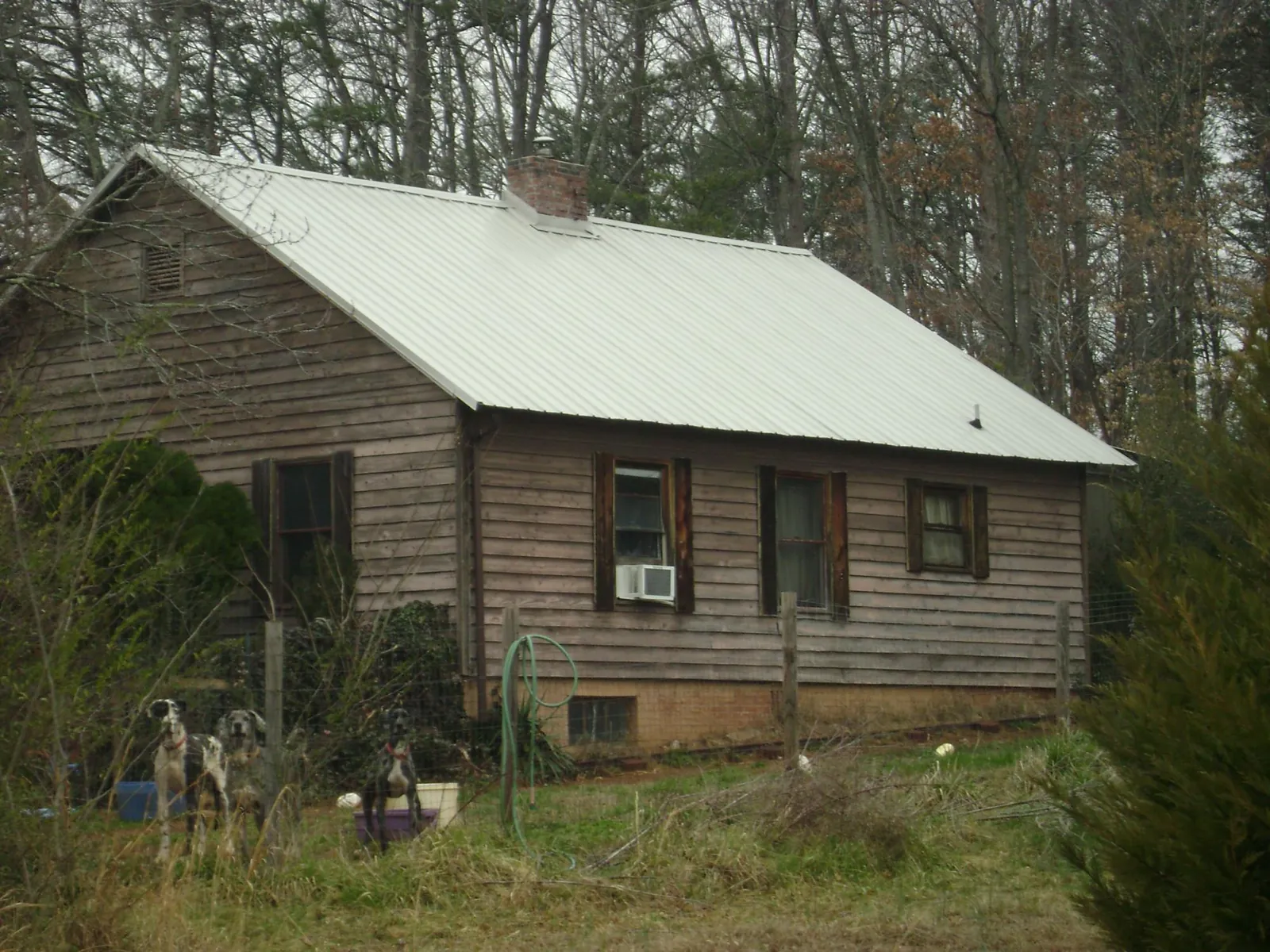 White metal roof on an old wood sided farmhouse, from a Metal Roof Installation job in Schoenchen